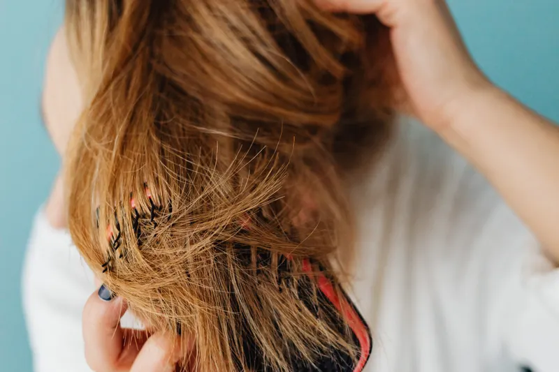 Woman running her fingers through long hair